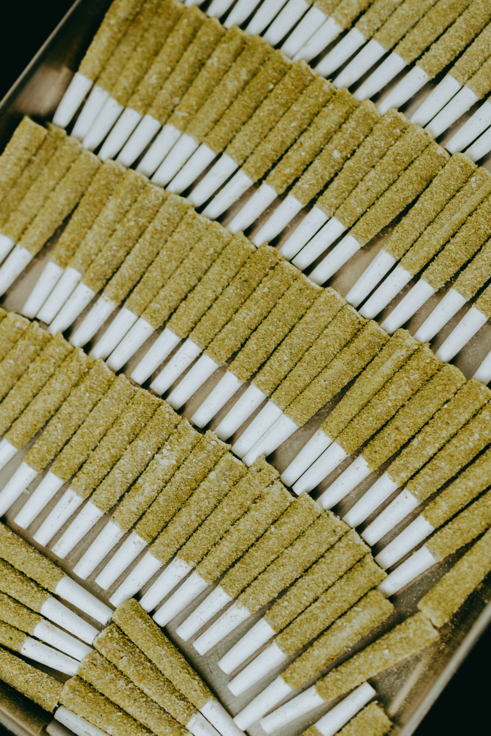A full tray of infused and coated pre-rolls at Gotham Manufacturing