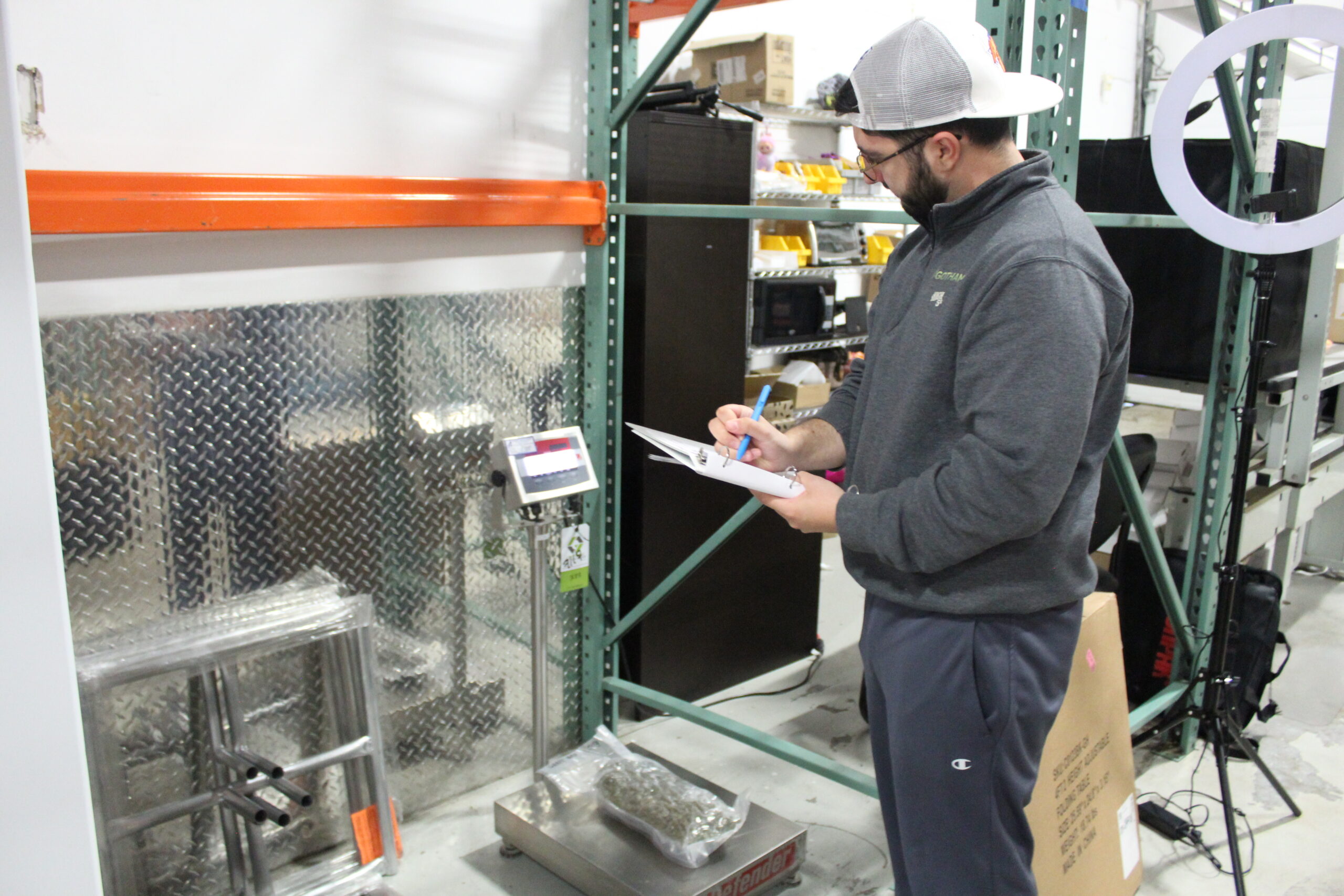 A worker weighing a bag of flower on a receiving scale