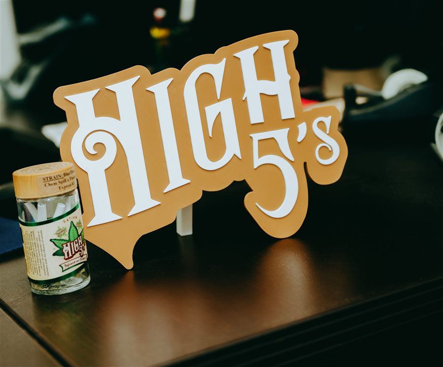 The High 5's brand sign next to a labeled jar of real product