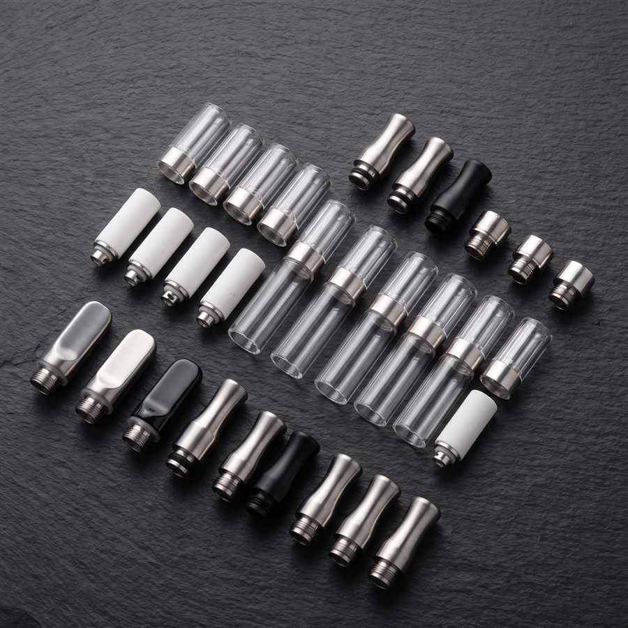 Assorted vape cartridge hardware components in different colors and materials